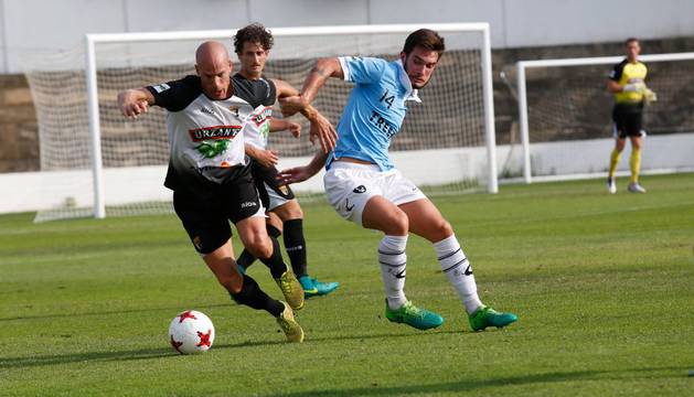 Fernando Delgado se lleva el balón ante Borja con Meseguer siguiendo la jugada desde atrás con la vista.