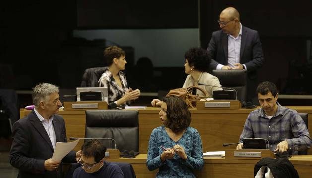 Parlamentarios de Geroa Bai, Podemos y PSN, en el hemiciclo de la Cámara, antes del inicio de la sesión plenaria del Parlamento.