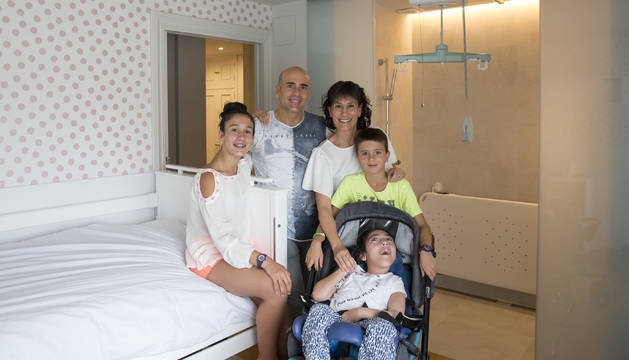 David Erice y Míriam Morteruel, con sus tres hijos: Adriana, Álvaro y Anne. La familia posa en la adaptación adaptada de Anne. Un sistema de rieles en el techo permite trasladarla con grúa de la cama a la camilla.