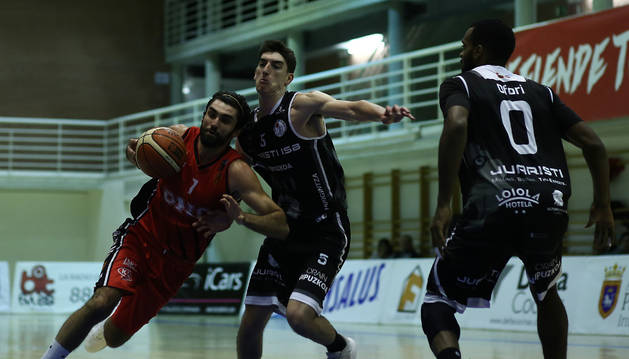 Foto de José Jiménez protege el balón ante la defensa de Azpeitia y Brian del Juaristi.