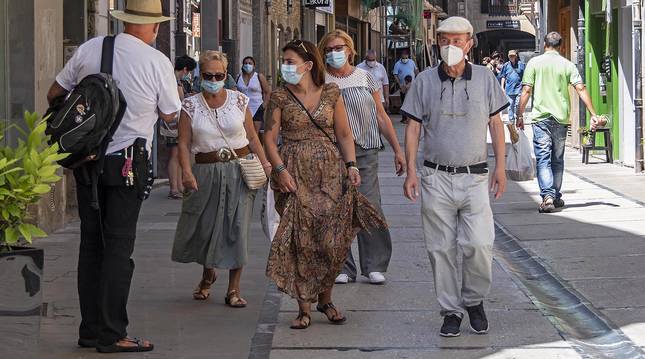 Viandantes en la calle Mayor ayer por la mañana, con las mascarillas generalizadas en la ciudad.