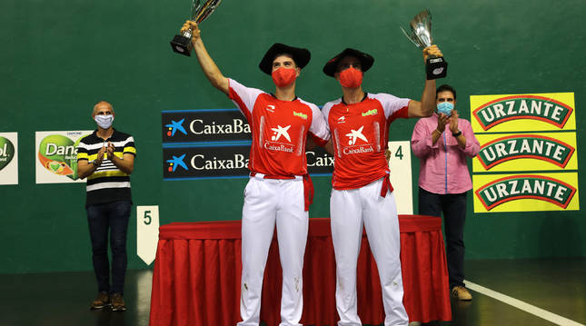 Eskiroz y Agirre, protegidos con mascarillas en el momento de recoger la txapela de campeones, con Rubén Beloki a la izquierda, uno de sus mentores.