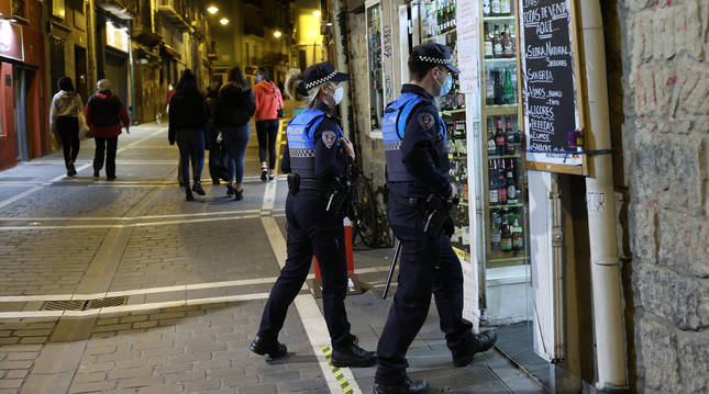 Policía Municipal de Pamplona entra en una tienda para comprobar que todo está en orden.